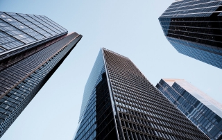 UK, London, low angle view of city financial district skyline illuminated at sunset